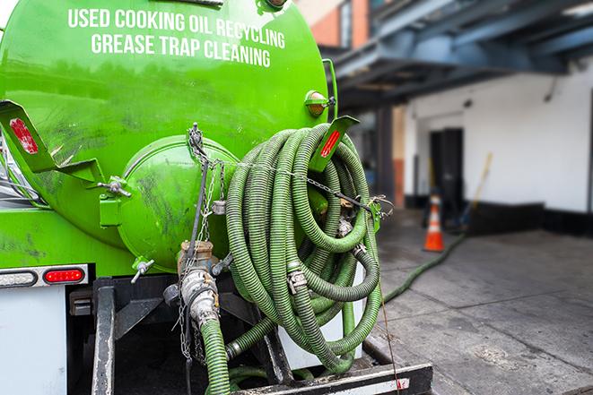 a service truck pumping grease from a restaurant's grease trap in Hermosa Beach